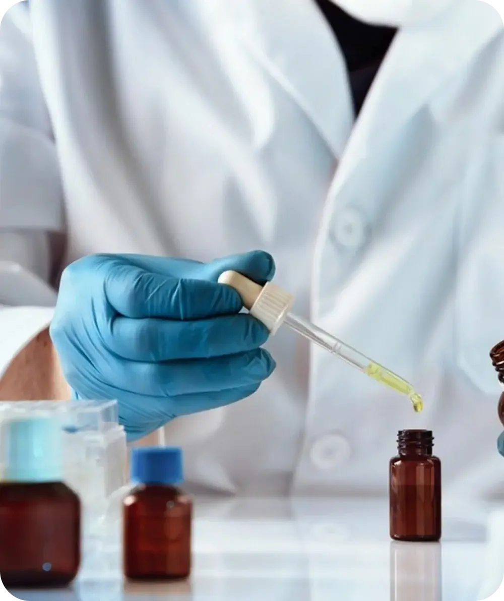 Pharmacist measuring a liquid medication with a dropper