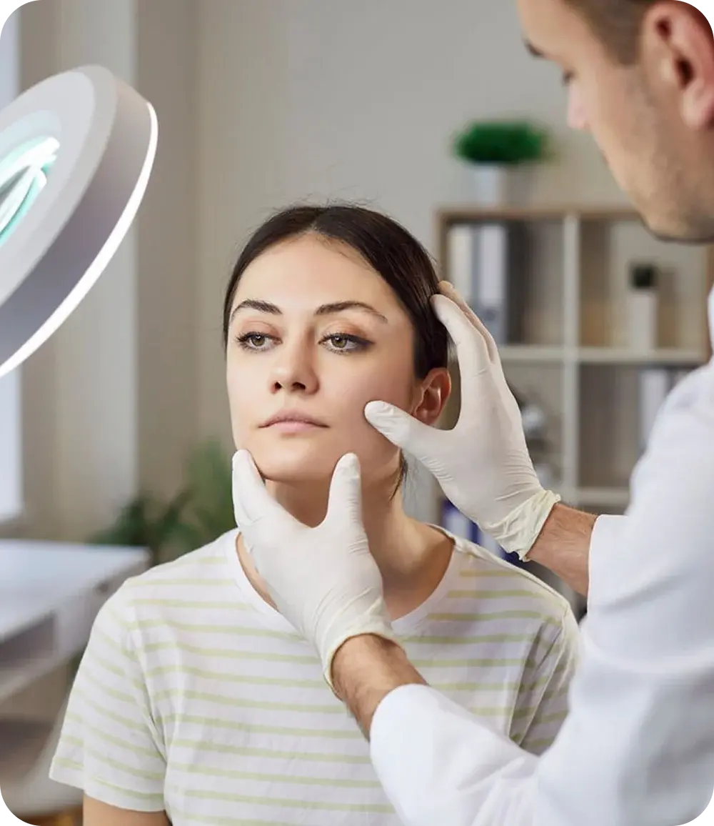 Dermatologist examining a patient’s face