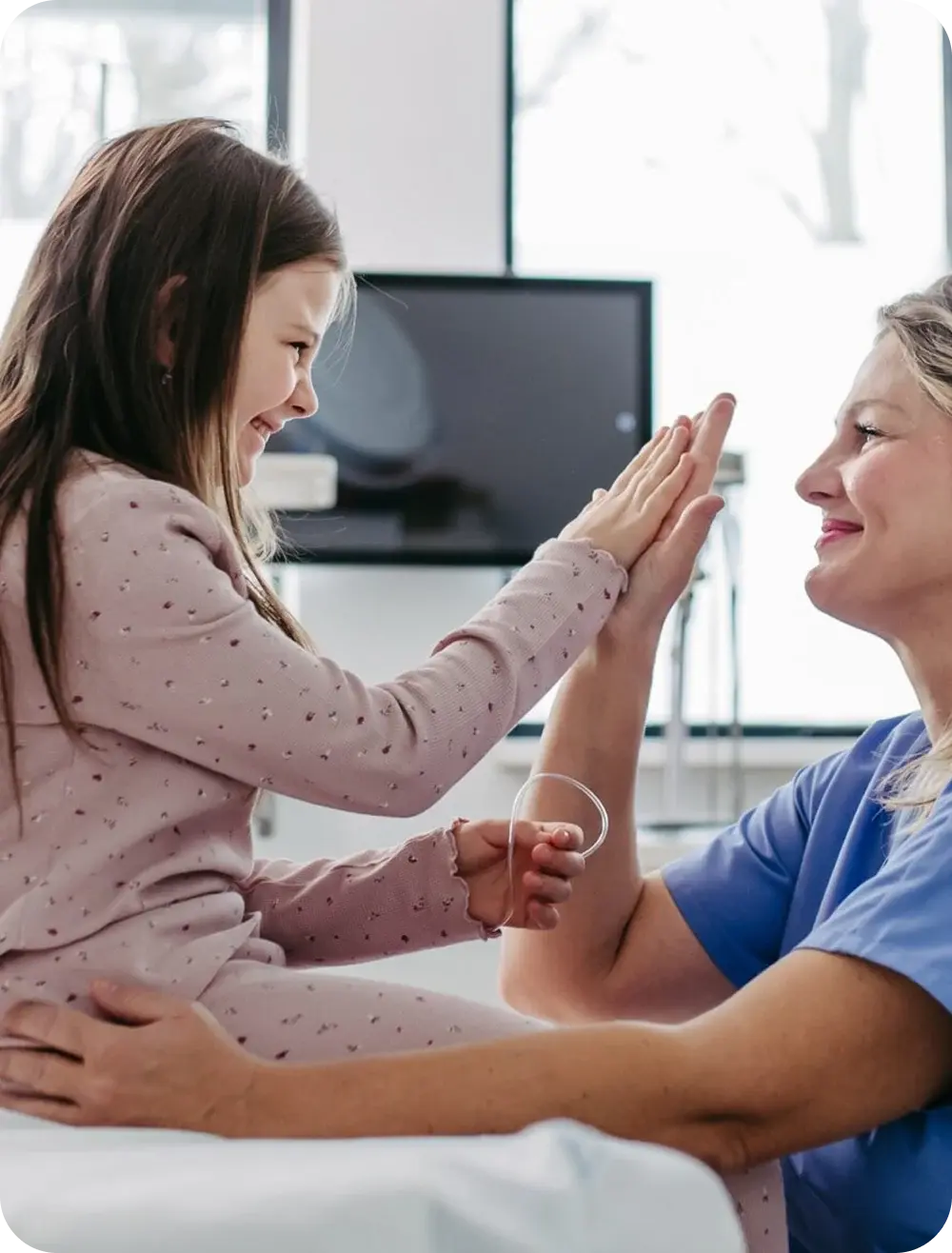 Child giving a high five to a nurse