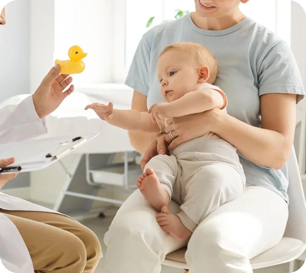 Pediatrician with a parent holding a baby