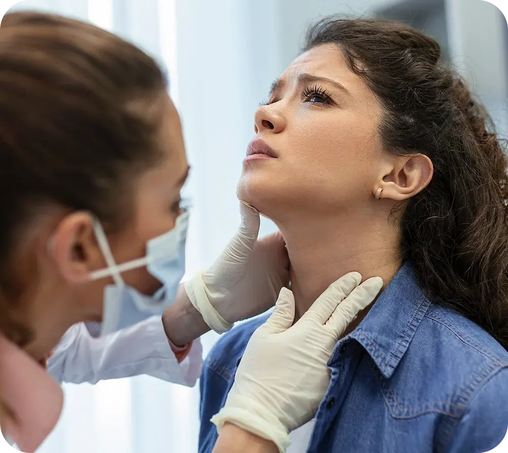Doctor examining a patient’s thyroid