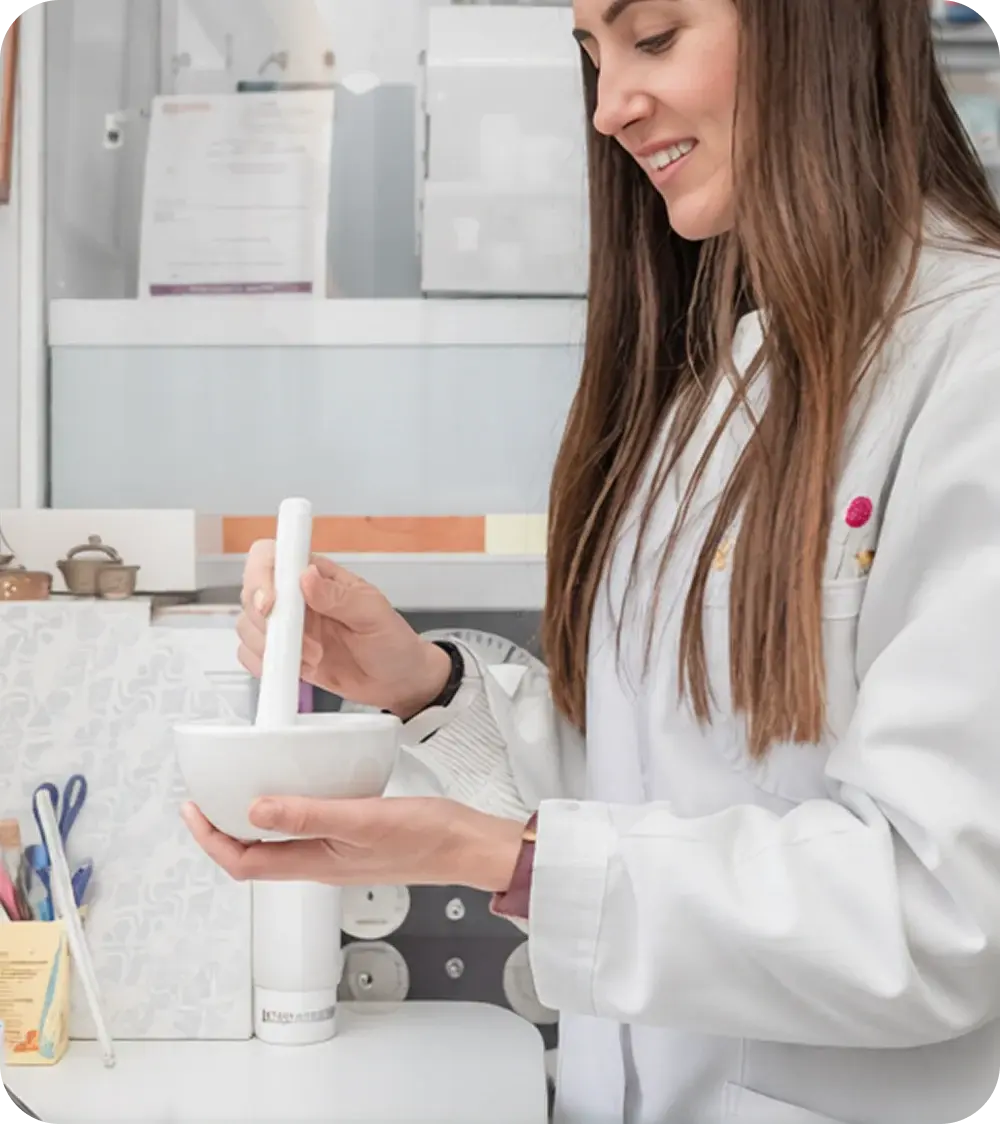 Pharmacist grinding medication with a mortar and pestle