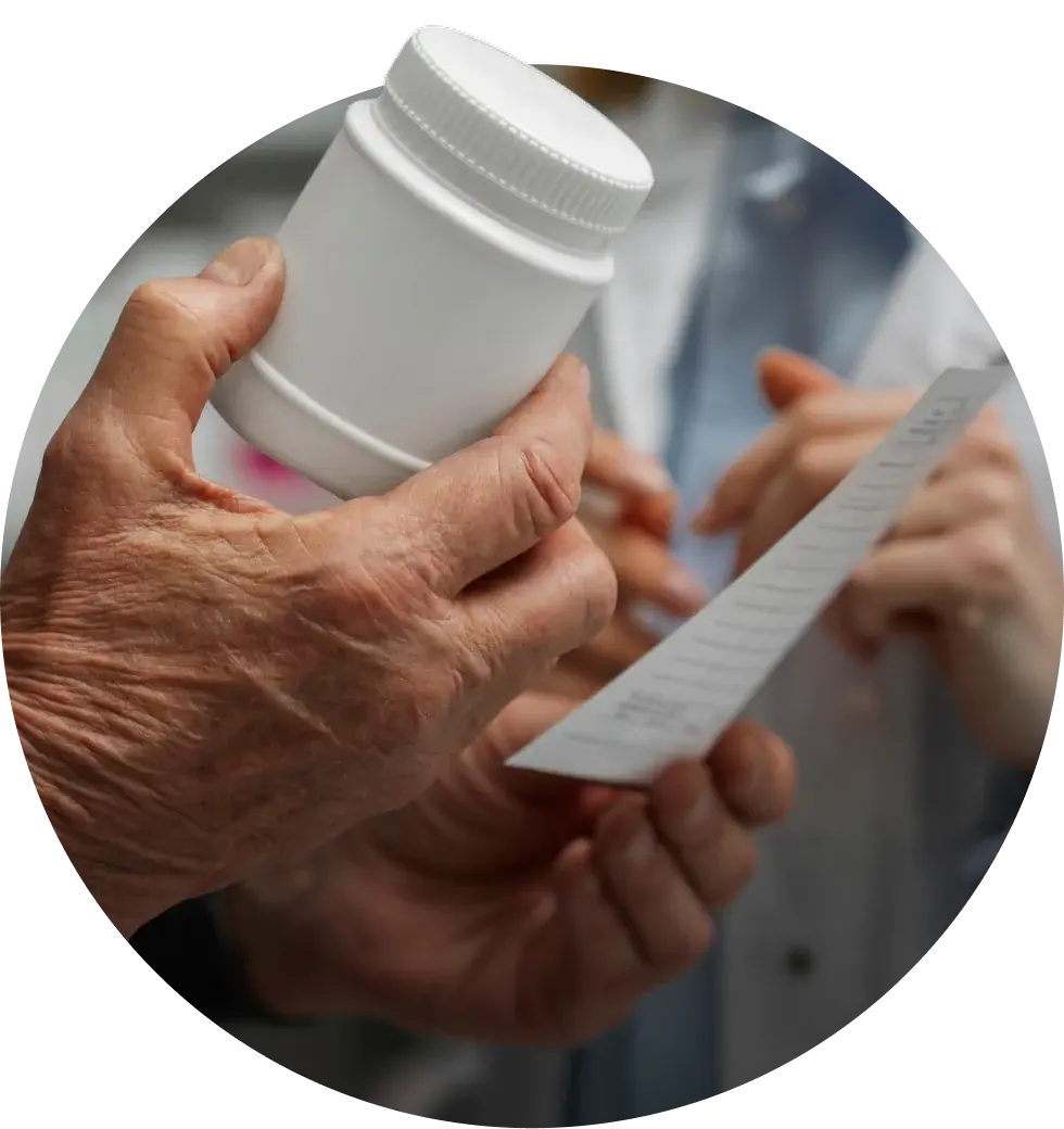 Hands passing a prescription bottle and a printed label