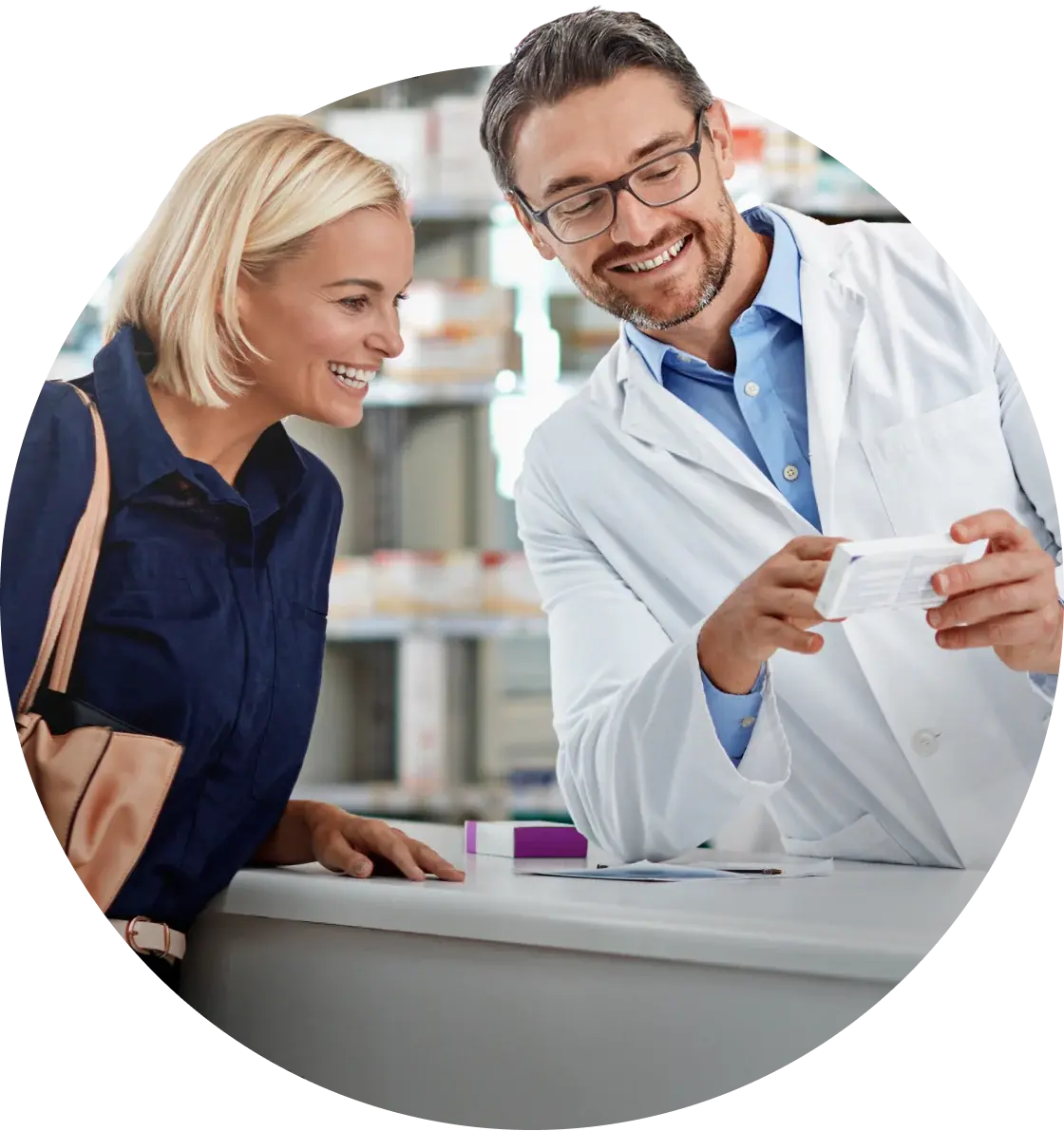 Pharmacist showing a medication box to a smiling customer at the counter