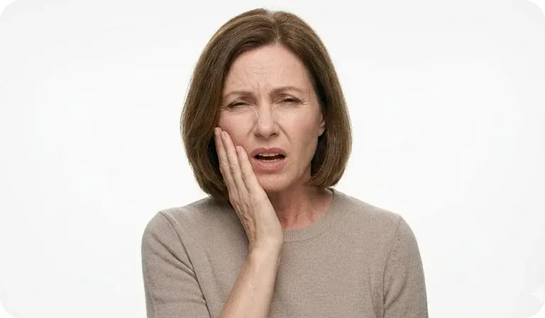 Woman holding her jaw with tooth pain